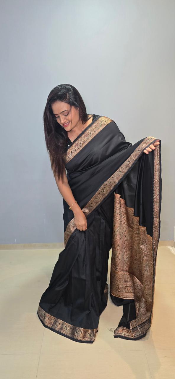 A Parnika black silk sari with antique gold border, draped editorial style